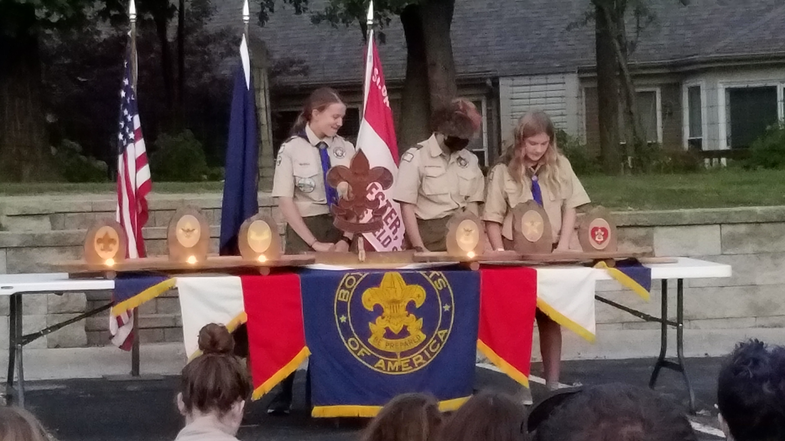3 Scouts behind a court of honor table