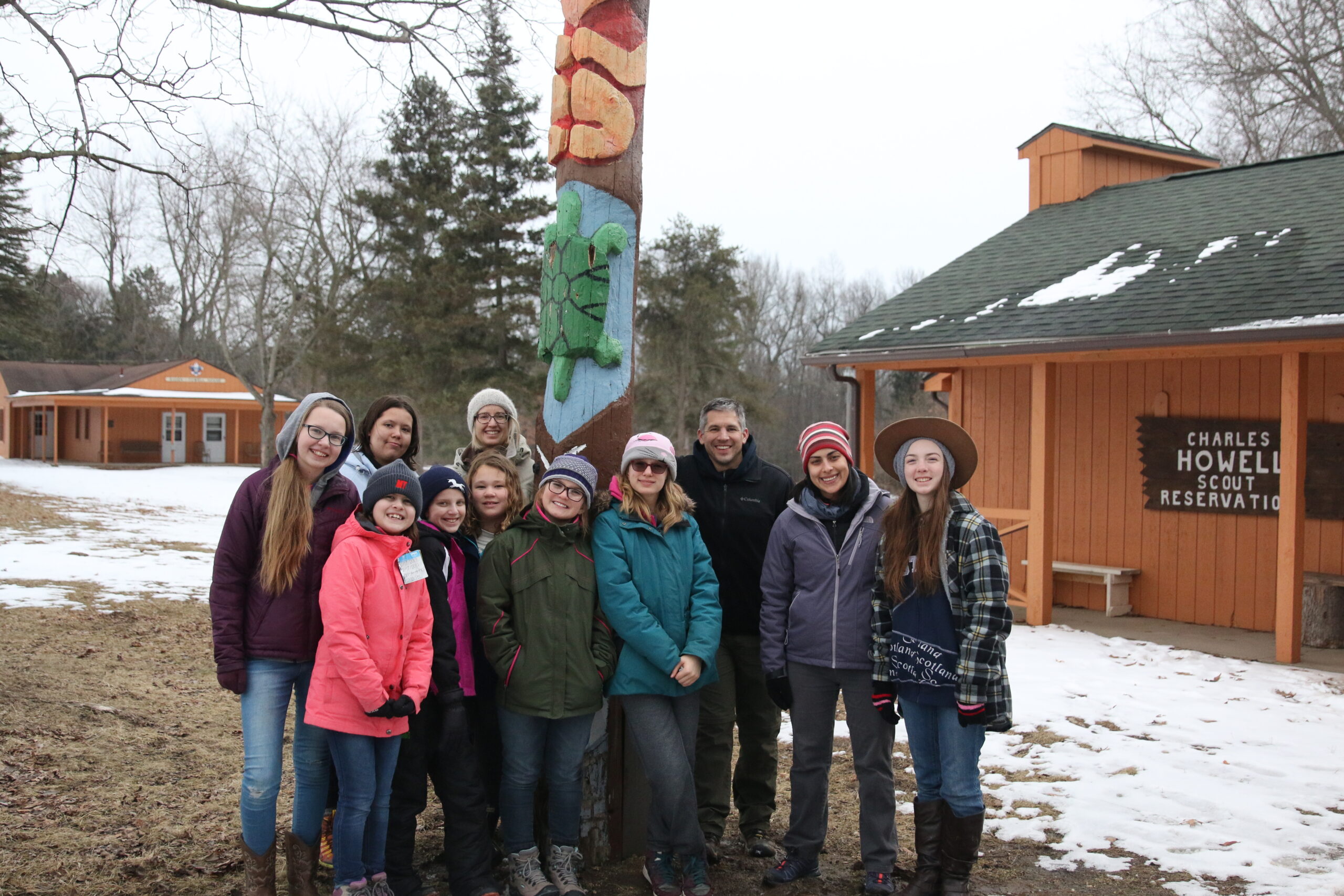Scout troop in front of a totem pole