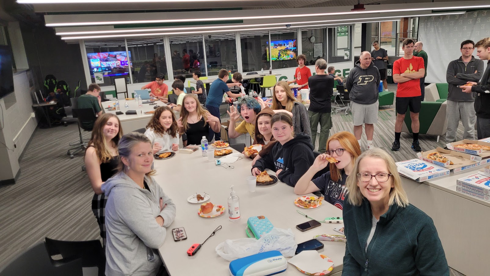 Troop 456 sitting at a long table at Eastern Michigan University athletic center for a lockin.
