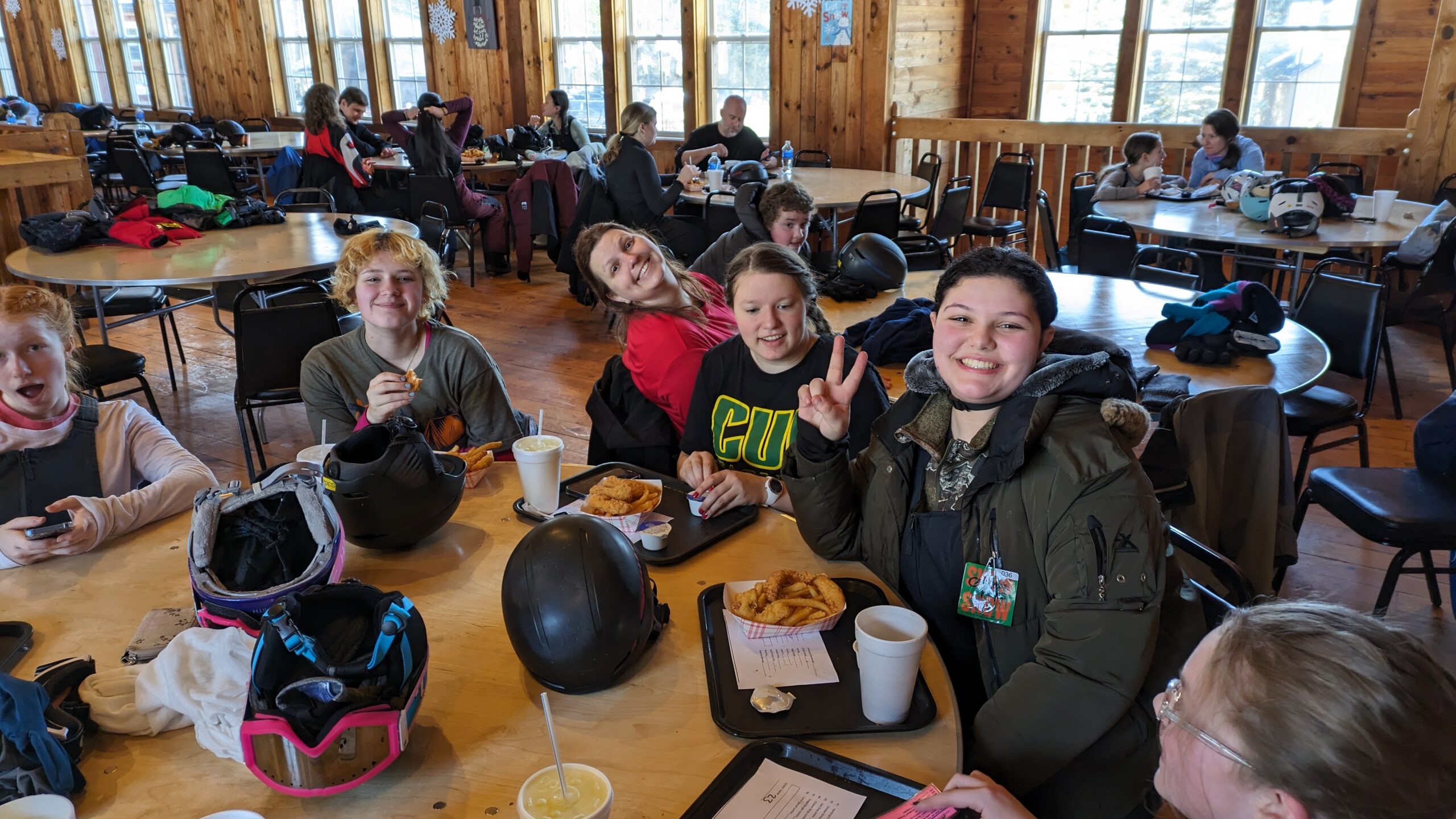 Scouts sitting around a table warming up after skiing