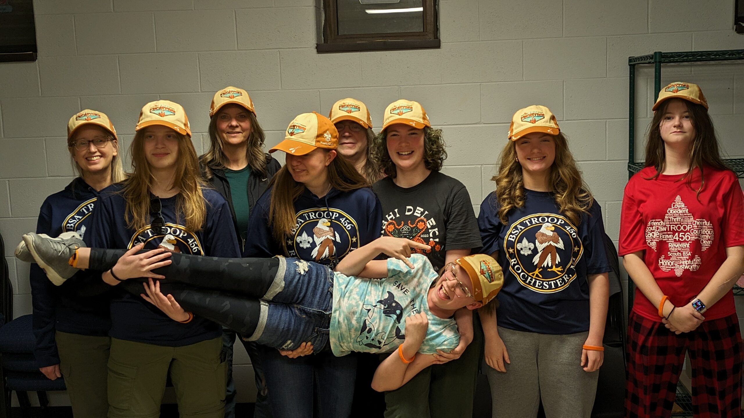 Scouts holding another scout up.