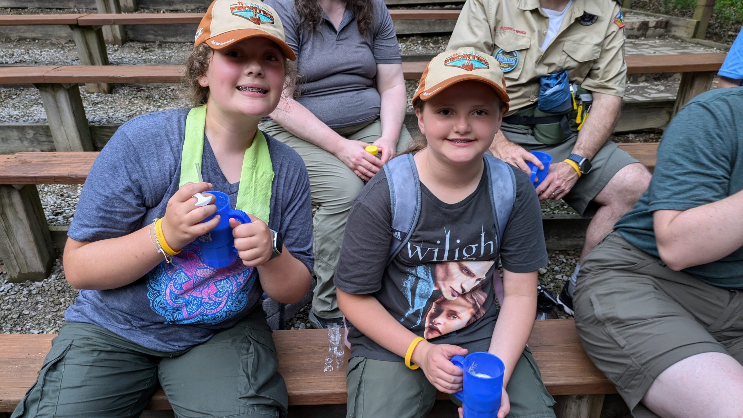 2 scouts sitting on a bench at camp